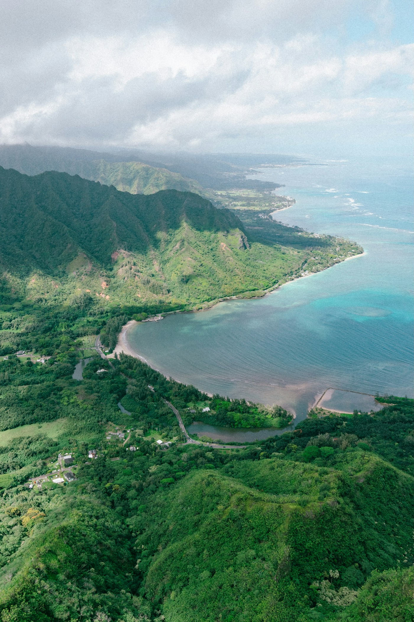 Green mountain ridges and neighborhoods along Oʻahu’s windward coast